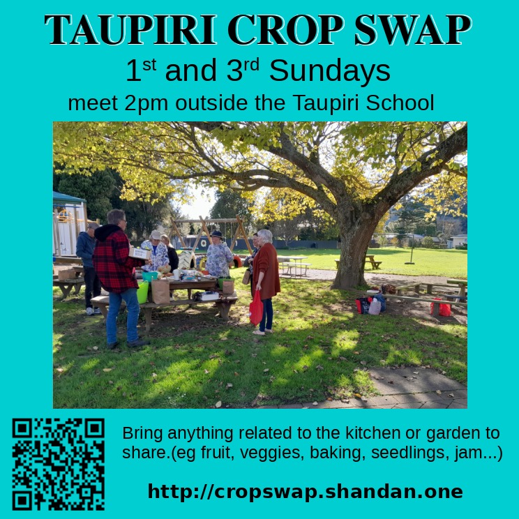 Crop swappers chatting away around a table of produce on scenic Taupiri School grounds.