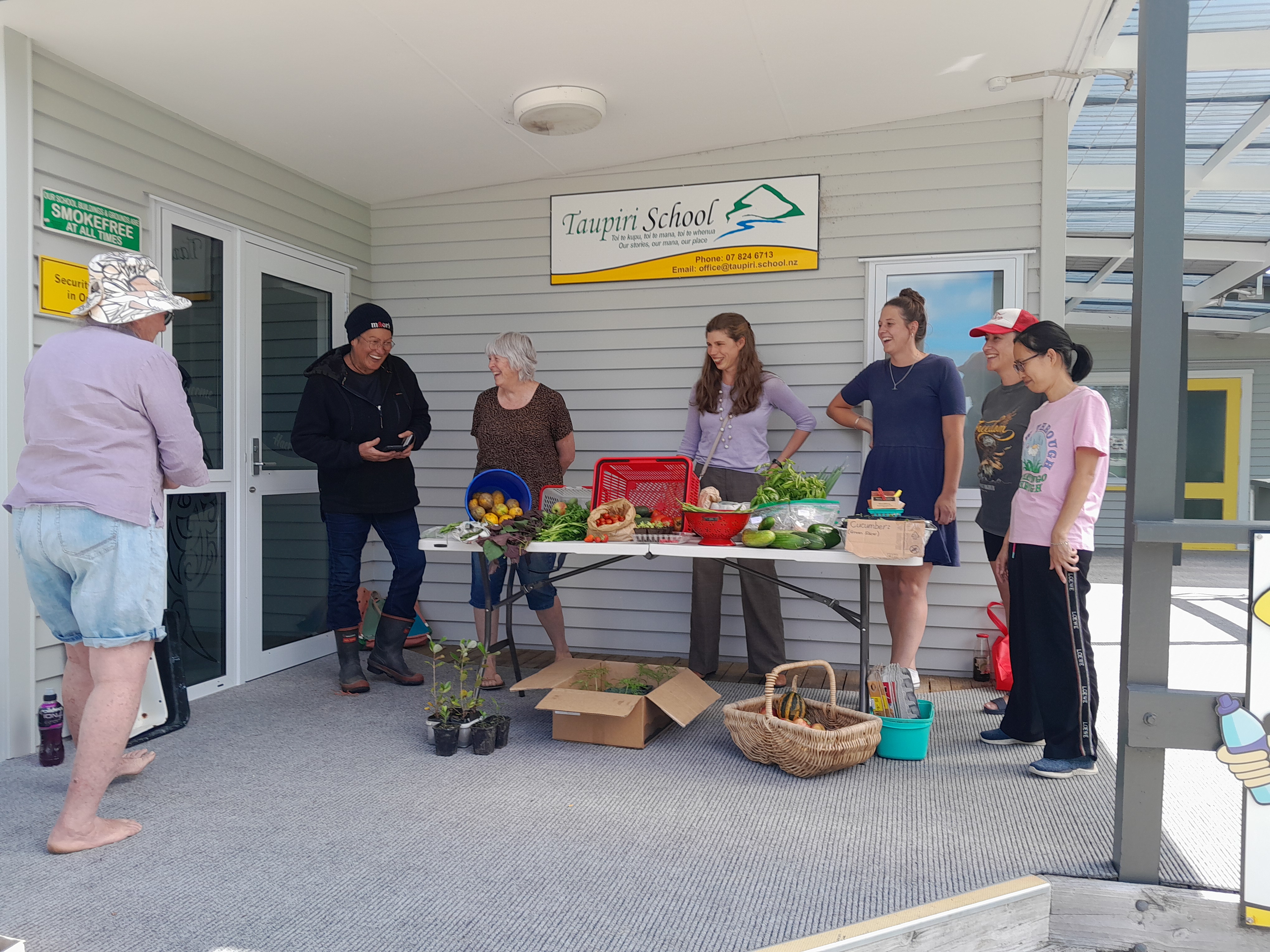 Crop swappers chatting away around a table of produce to swap on 17th March.